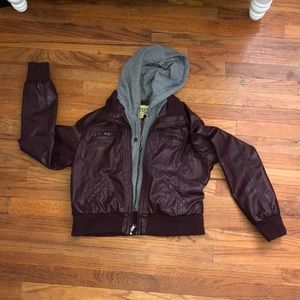 Leather jacket with sweatshirt decal.